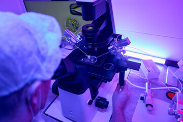 Genetic laboratory worker looking on cell at display