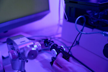 Male laboratory worker controlling joystick of micromanipulator