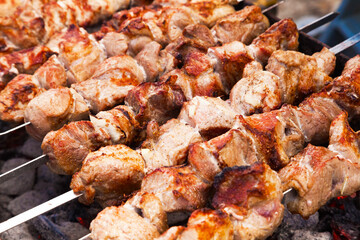 Grilled meat on skewers, close-up. Fried fillet pieces on grilled skewers.