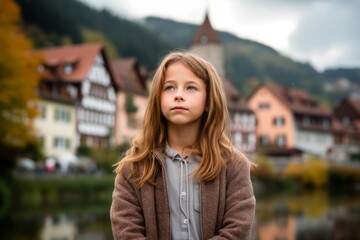Headshot portrait photography of a glad kid female meditating against a quaint european village background. With generative AI technology - obrazy, fototapety, plakaty