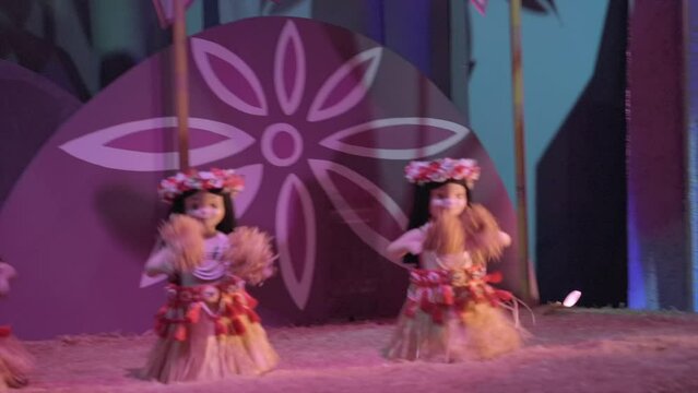 This video shows animatronic hula girls dancing in a colorful and whimsical setting.