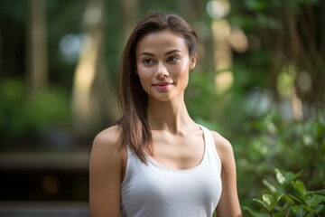 Fototapeta premium Photography in the style of pensive portraiture of a happy girl in her 30s working out against a serene zen garden background. With generative AI technology