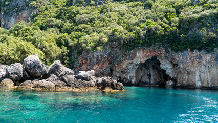 Naklejka na ściany i meble Beautiful typical Albanian coastline with hidden caves and crystal clear water