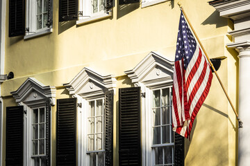 An American flag hanging outside of a colonial era home in Charleston, South Carolina.
