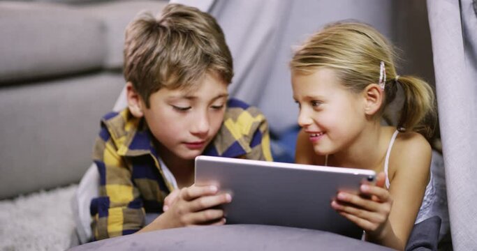 Children with tablet in tent, girl and boy with technology at home, reading ebook or play games. Family, kids bond with tech gadget, elearning or video game, relax and watch cartoon online in fort