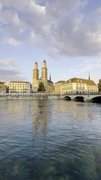 Vertical video of the Grossm&uuml;nster Church on the Limago river in Zurich, Switzerland.