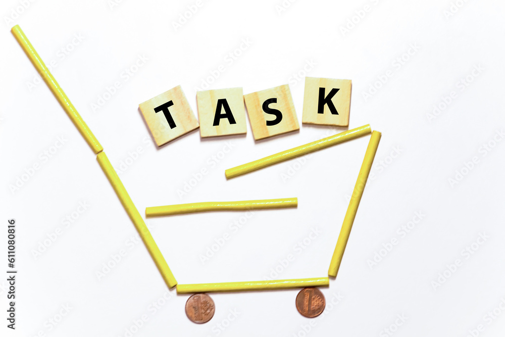 Poster word task on wooden block on a black notebook with smartpone, credit card and magnifier.