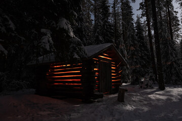 Forest woodshed illuminated with orange light under full moon - Powered by Adobe