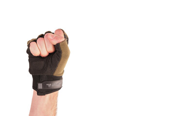 tactical military glove without fingers olive for hand protection. Dressed on the arm. The fingers are folded into a fist - obrazy, fototapety, plakaty