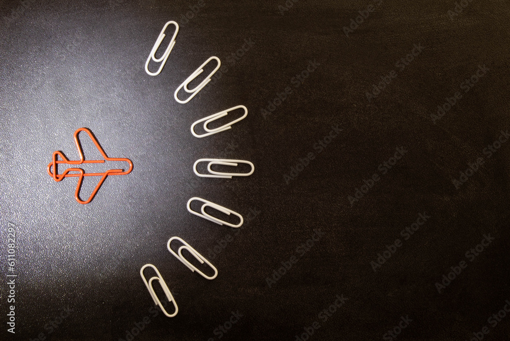 Poster Concept image of unique thinking. Paper clips in the shape of airplane.