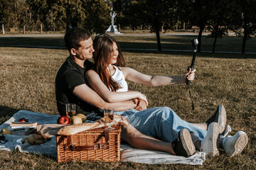 Young couple having a picnic in the park.