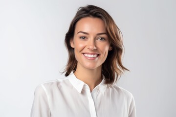 Fototapeta premium Medium shot portrait photography of a grinning girl in her 30s wearing a sophisticated blouse against a white background. With generative AI technology