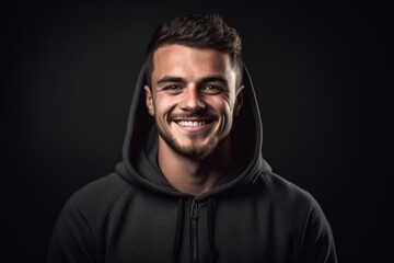 Fototapeta premium Headshot portrait photography of a grinning boy in his 30s wearing a comfortable hoodie against a minimalist or empty room background. With generative AI technology