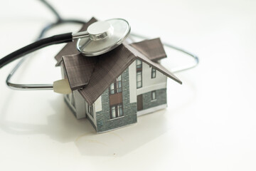 House check. miniature house and stethoscope