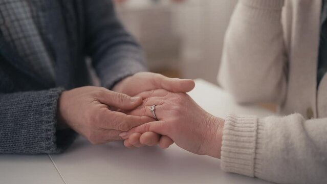 Closeup of senior man doing marriage proposal, giving engagement ring, happiness