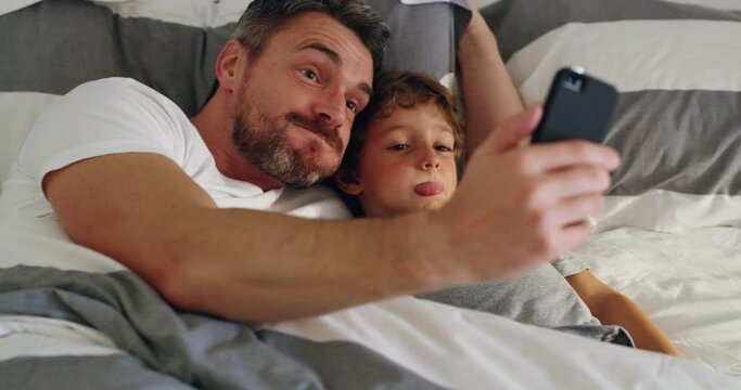 Crazy, selfie and father with child in a bed happy, bond and embrace in their home. Silly, face and kid with parent in a bedroom with goofy expression for photo, memory or profile picture indoors