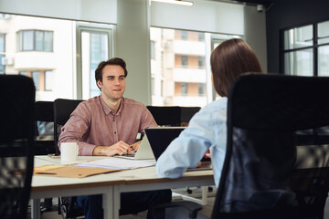 Young manager holding business meeting with company employee