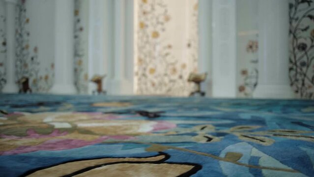 Close-up of beautiful modern carpet pattern. Scene. Beautiful carpet pattern on background of expensive interior of room. Carpet and wall patterns in beautiful expensive room interior