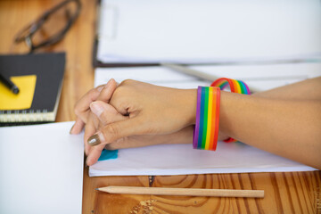 lgbt Q couple wore rainbow wristbands symbolizing lgbt Q group and held hands to show love,...