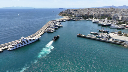 Aerial drone photo of beautiful yacht manoeuvring inside round port of Zea or Passalimani a safe...