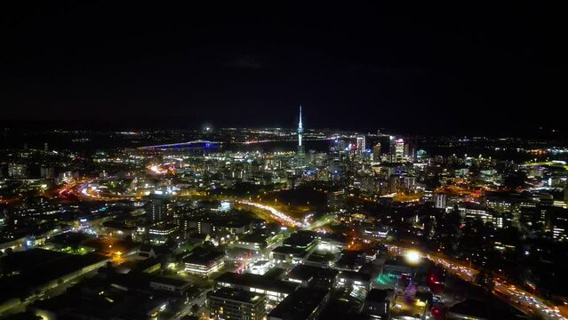 Aerial View of Auckland City Skyline at Night. Moving forward towards the CBD and Sky Tower. 