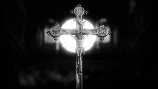 Crucifix Jesus Backlit Lights Flickering Retro Style, Old Film Texture. Crucifix of Jesus statue lighten by bright lights flickering, vintage style. Old film texture