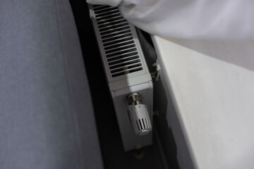 Thermostatic radiator valve. A valve for regulating the radiator temperature. Controling the temperature of a room. Thermostat. White radioator valve set to highest temperature.