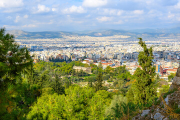 The ancient Greek Temple of Hephaestus rises above the ruins and parks of the ancient agora at the base of the Acropolis Hill in Athens Greece