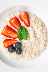 fresh oatmeal breakfast porridge berries healthy meal food snack on the table copy space food background rustic top view
