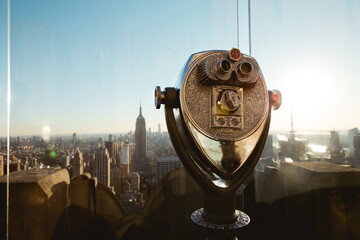 View of the Manhattan skyline and coin-operated binoculars from an aerial panoramic view, lit by...