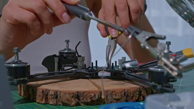 side view woman Doing Soldering Iron Job Technologies in Unmanned Aerial Vehicle Concept