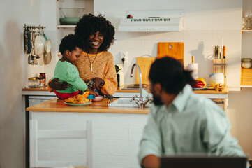 A happy multicultural family at home in the morning.