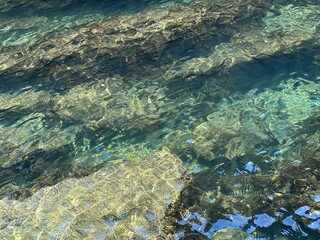 Sea water aqua stones underwater background.