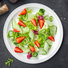 strawberry salad cucumber, lettuce healthy meal food snack on the table copy space food background rustic top view 