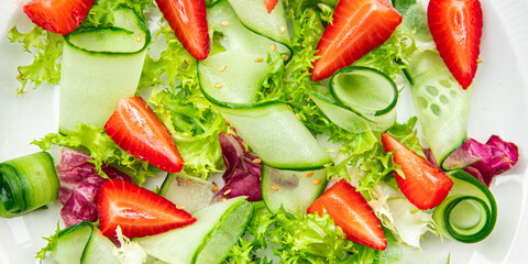 strawberry salad cucumber, lettuce healthy meal food snack on the table copy space food background...