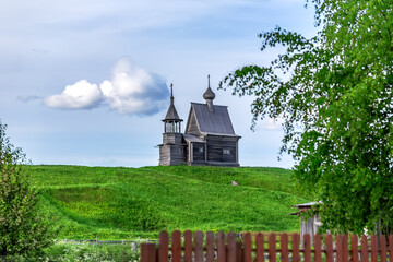 Obraz premium Russian Traditional Wooden Church (Chapel) Of St.Nicholas On The Top Of Hill In The Vershinino Village. Kenozero Lake,Kenozersky National Park.