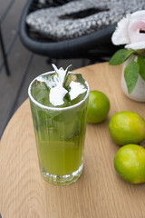 Mojito and lime top view of street cafe table. Summer fresh alcoholic cocktail