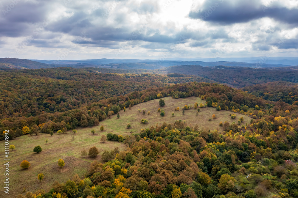 Wall mural aerial view of mountain and valley covered with autumn colors.