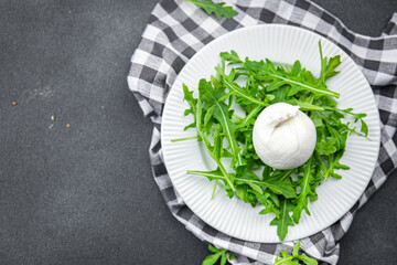 buratta salad arugula green leaves cheese burratina healthy meal food snack on the table copy space food background rustic top view