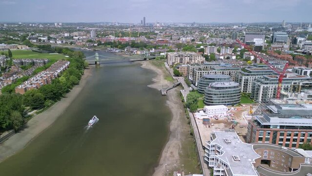 The drone aerial footage of Hammersmith bridge across River Thames in west London, links Hammersmith and Barnes.