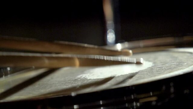Unrecognizable musician man drummer is playing hitting drum on drums kit.