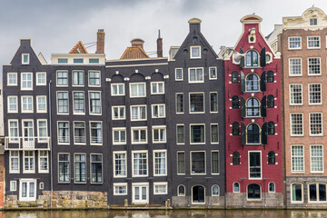 Fototapeta premium front view buildings amsterdam holland canal crooked buildings
