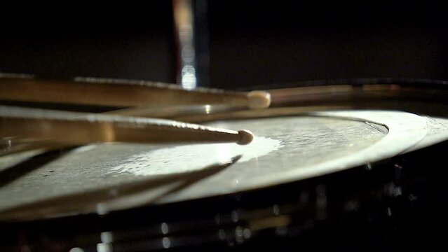 Unrecognizable musician man drummer is playing hitting drum on drums kit.