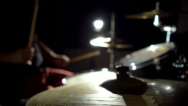 Unrecognizable musician man drummer is playing hitting performing on drum kit.