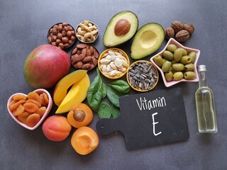 Food rich in vitamin E (tocopherol). Natural products containing vitamins, dietary fiber and minerals. Healthy sources of vitamin E, healthy diet food. Avocado, mango, oil, olives, seeds, apricot nuts - obrazy, fototapety, plakaty