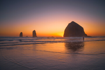 sunset over haystack rock at cannon beach