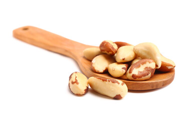 Wooden spoon with tasty Brazil nuts on white background