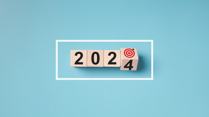 2024 New Year wooden blocks change on blue background. Starting 2024 progress bar goal plan wood...