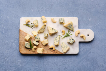 Board with pieces of tasty cheese on grey background