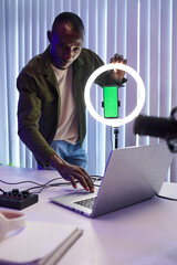 Obraz premium Blogger setting ring light before recording video for his channel